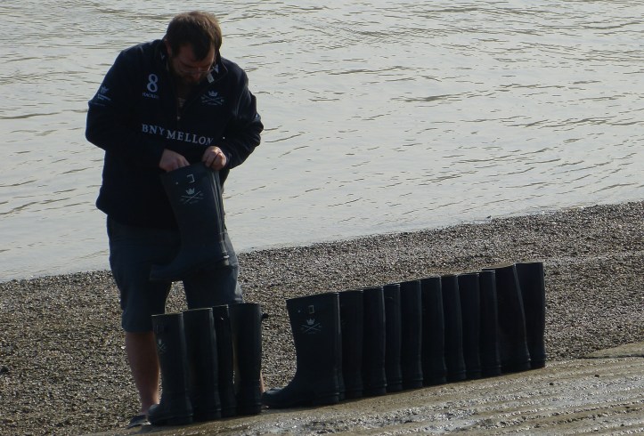 The Oxford boatman arranges the boots belonging to Isis (Oxford men’s reserves) in crew order, ready for their return from their outing. I suggested that he put ‘L’ or ‘R’ on them as well.