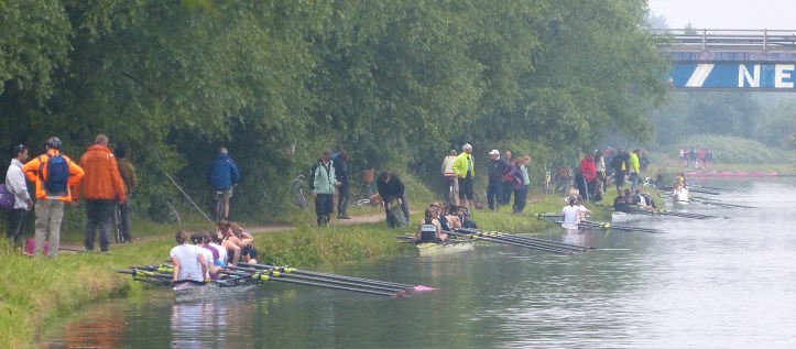 Pic 4. Women’s Division One on the start on the final day of the 2015 Mays. From left to right is Downing, Caius, Emmanuel, Jesus, Clare and the boat club of Trinity College, First & Third.