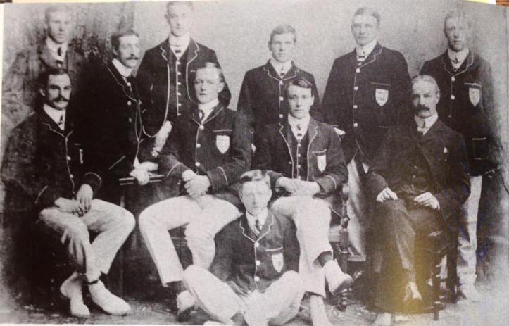 The 1903 TCD senior eight, winners of the Thames Cup at Henley Royal Regatta. Back row: (L to R) E.L. Julian (coach), H.B. Mayne (6), W.F. Fox (bow), J. Cunningham (2), M.P. Leahy (3), J. du P. Langrishe (7). Front row: A.A. McNeight (4), H.A. Emerson (5), E.B. Bate (cox, in front), F.J. Usher (stk.), R.C. Lehmann (coach).