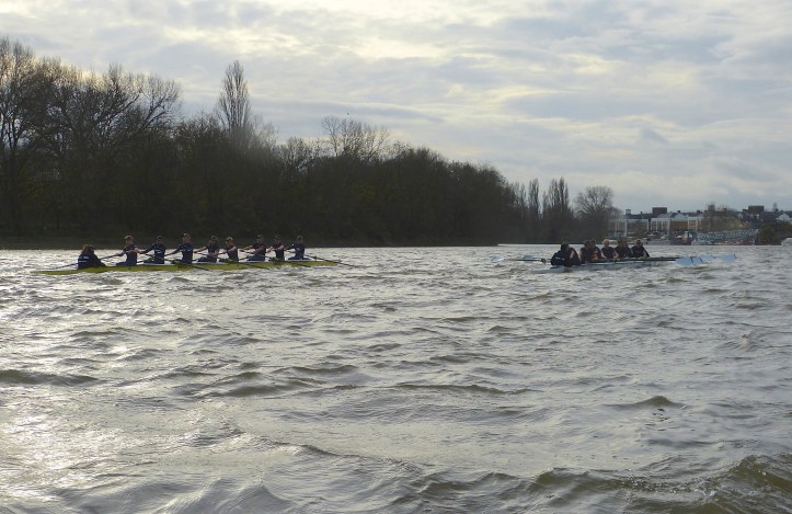 Pic 12. Something remarkable happened after the crews went through Hammersmith Bridge and past St Paul’s School. As often happens around the Chiswick bend, the water conditions worsened and Scylla, now with a two length lead, failed to cope with this change as well as did Charybdis. Further, Scylla cox Antonia Stutter moved too far to Middlesex and her opposite number, Morgan Baynham-Williams, took full advantage of this and Charybdis started to move closer to her opponents.