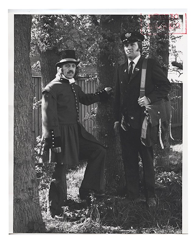 River postmen operated on the River Thames from 1800 to 1952, delivering mail to boats moored from London Bridge to below Limehouse. This river postman's full skirted frock coat is made of scarlet broadcloth. The shoulders of the coat are capped with the same scarlet cloth as the body of the coat and feature a black embroidered border. River postmen also operated in Poole and South Shields.