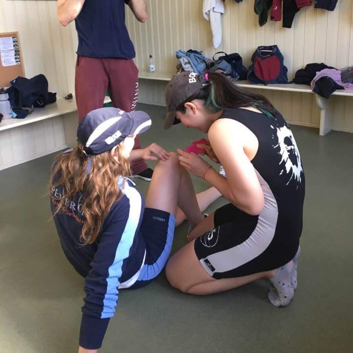 Picture 4 - Audrey helping our five-seat and fellow Architect student Emma apply tape to support her knees. These two are inseparable outside the boat. Photo CL, with an iPhone 6 and VSCO.