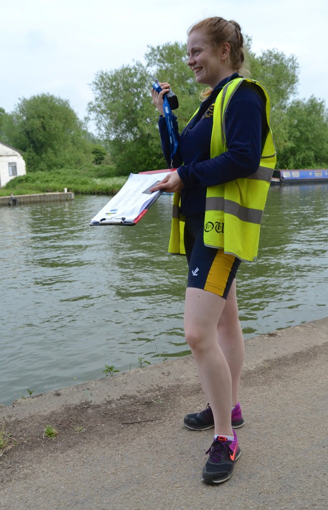 Pic 16. Stella, from the University College Women’s First Boat, takes her turn at marshalling. A huge number of people are required to make the event run safely and efficiently, so each boat club is assigned a number of marshalling and umpiring slots depending on the number of crews that it entered and it is fined should it fail to fill those slots.