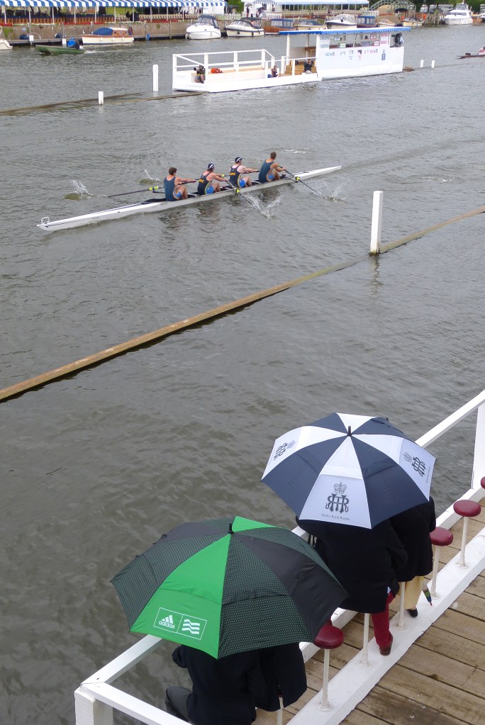 It was not a pair of pink socks or a club blazer that was the ‘must have’ accessory for Henley Wednesday, it was in fact a large and sturdy umbrella. Here, some die-hards watch Nottingham Rowing Club in their defeat by Thames RC home in the Wyfold Challenge Cup, the event for club coxless fours.