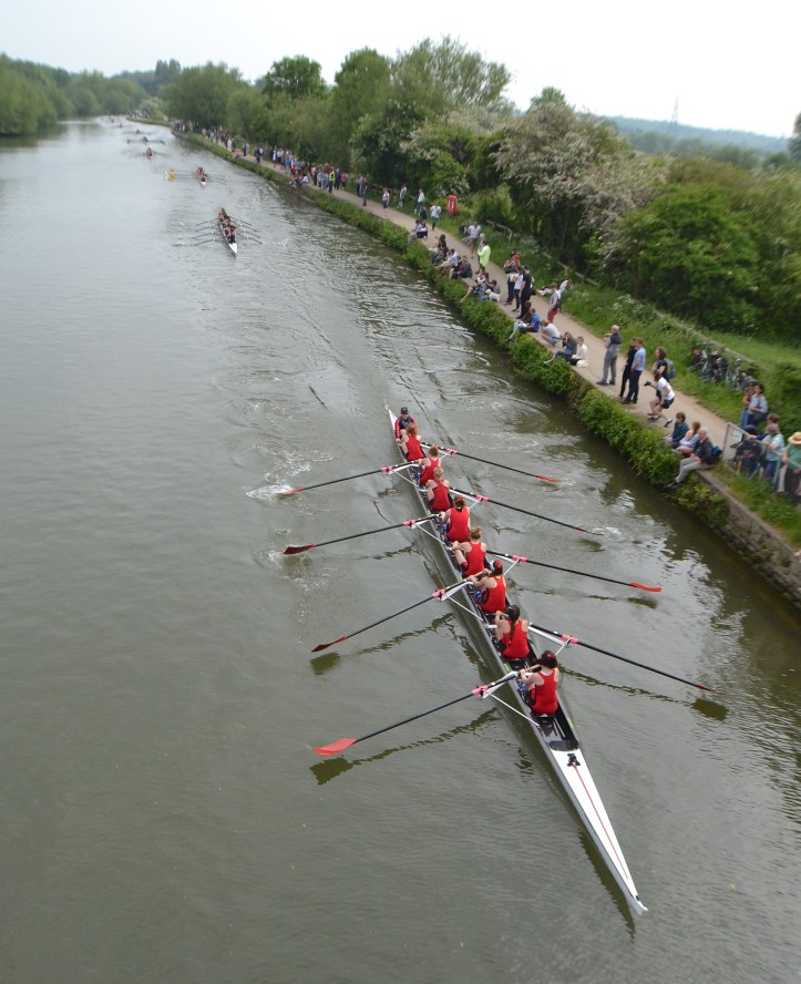 The starting cannon fires, the coxes drop their ropes and the crews go off, each boat having a two length advantage over the crew behind. The strange thing about bump racing is that, to progress, you need to be more than just a fraction faster than the people in front, you need to be ‘two boats plus’ faster. Here, Women’s Division III goes off with Exeter followed by Corpus Christi and then Wolfson II.