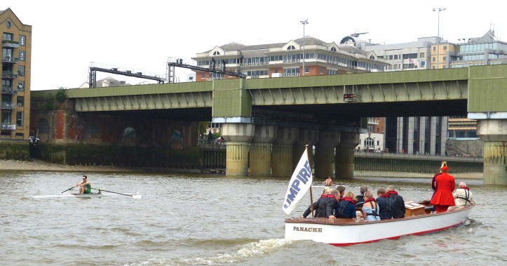 Unfortunate for them, but fortunate for the photographers, the two scullers on the left, Flynn and McCarthy, rapidly fell back leaving the leading three racing alongside each other in a tight and easy to photograph formation. Here Flynn leads McCarthy as they approach the second bridge on the course, Cannon Street bridge, 250 metres in to the 7,400-metre race.