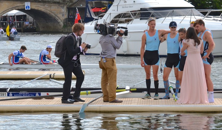 The winning Edinburgh crew get all the attention while, in the background, the losing Newcastle boys suffer alone.