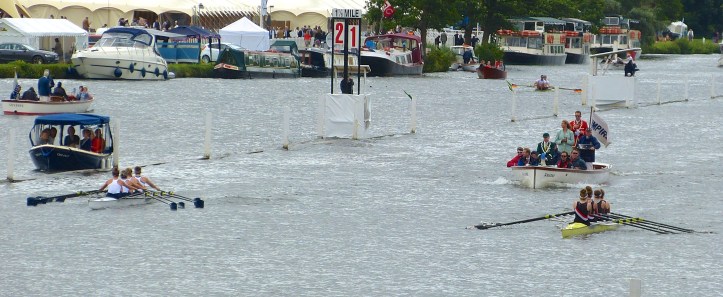 The Diamond Jubilee Challenge Cup (Junior Women’s Sculls) saw a great race between Henley RC ‘A’ (left) and Gloucester RC (right). As the indicator boards show, Henley were holding onto a slim lead at the Mile 1/8.