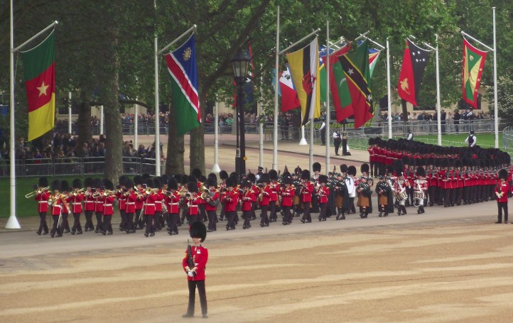Bandsmen of the Irish Guards arrive for the Trooping the Colour. They are distinguished from the Grenadier, Coldstream, Scots and Welsh Guards by the blue plumes in their bearskins. Also, on closer inspection, their buttons are arranged in fives and they have shamrocks on their collars. The distinctive saffron kilts of the pipers are also a clue.