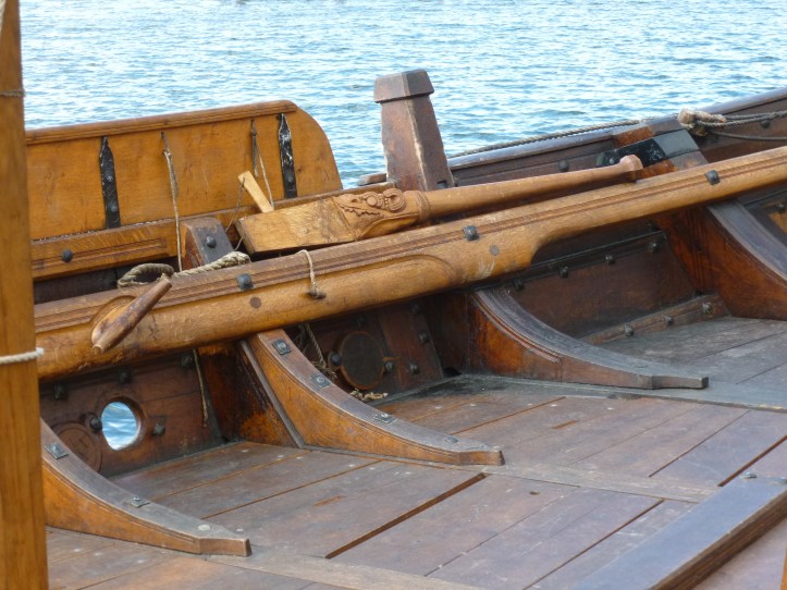 The tiller for the steering oar on starboard side.
