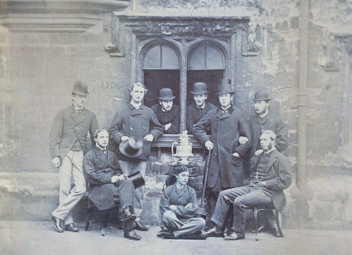 The triumphant if controversial 1865 Head of the River Eight. Standing from left: J. Rickaby, W.B. Woodgate, A. Shepherd, A.J. Richards, S.R. Coxe, R.F. Rumsey. Seated from left: P.A. Latham, C. Thompson, S.E. Illingworth.