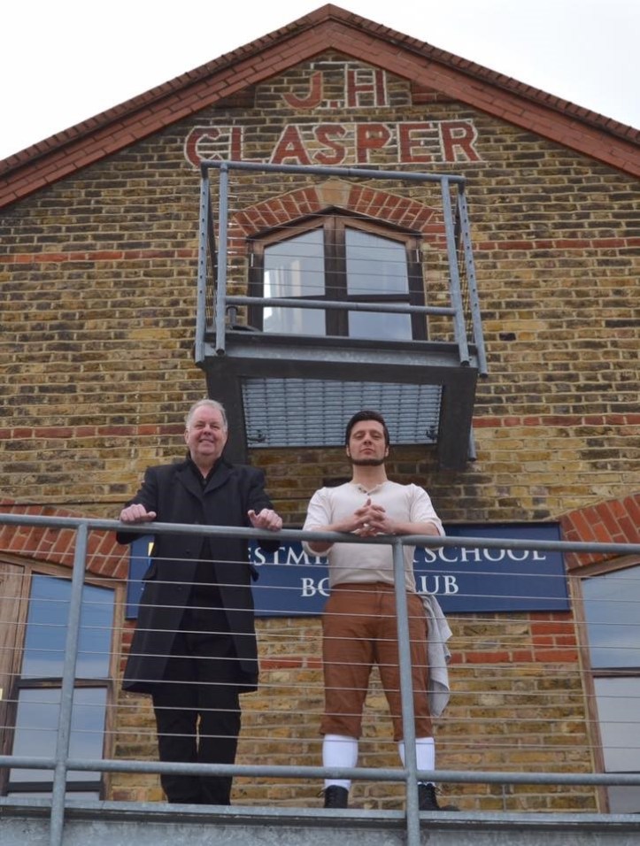 Ed Waugh and Jamie Brown on the balcony of Westminster School Boat Club under the iconic John Hawks Clasper sign. JHC was Harry’s son and emigrated to London to set up his own boat building business. Photo: Tim Koch.