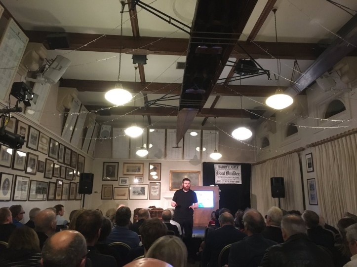 Keir Waugh, on stage in the bar of London Rowing Club, addressing the audience before the opening performance on Friday evening. Photo: Iain Weir @shutteritch.